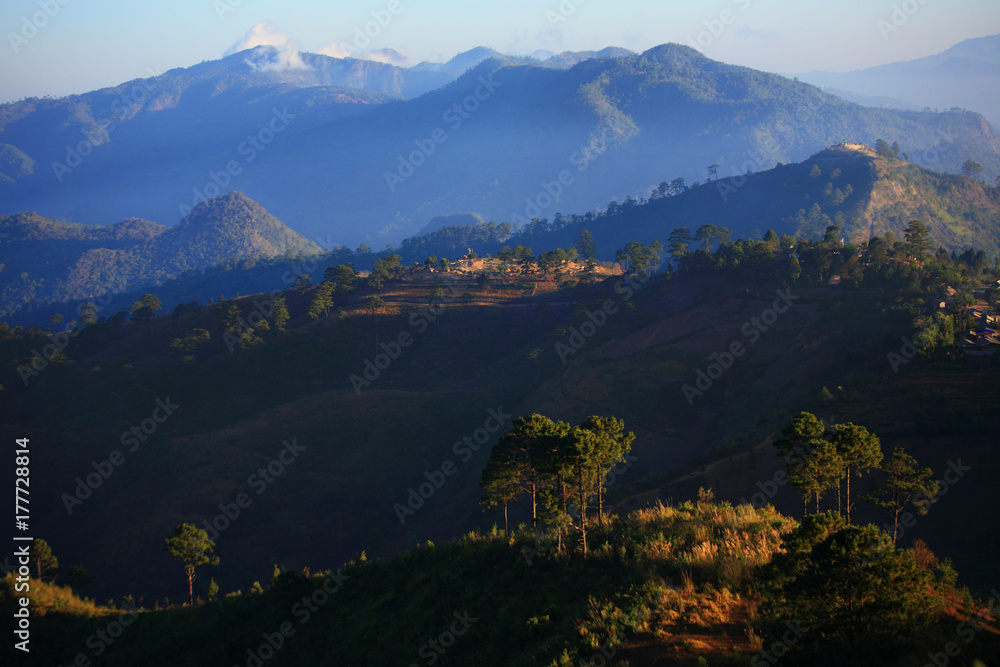 Panorama of the mountain range, Distant view of mountain range and colorful sky with light fog in the morning. Doi Ang-khang mountain, Chiang Mai, Thailand.