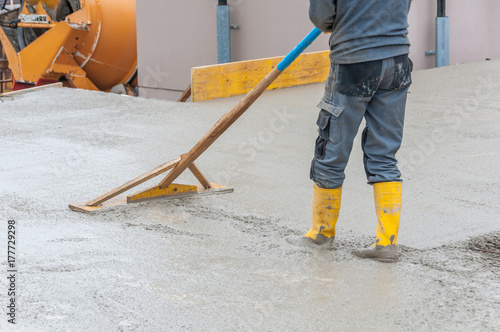 leveling fresh concrete on worksite © Redfox1980