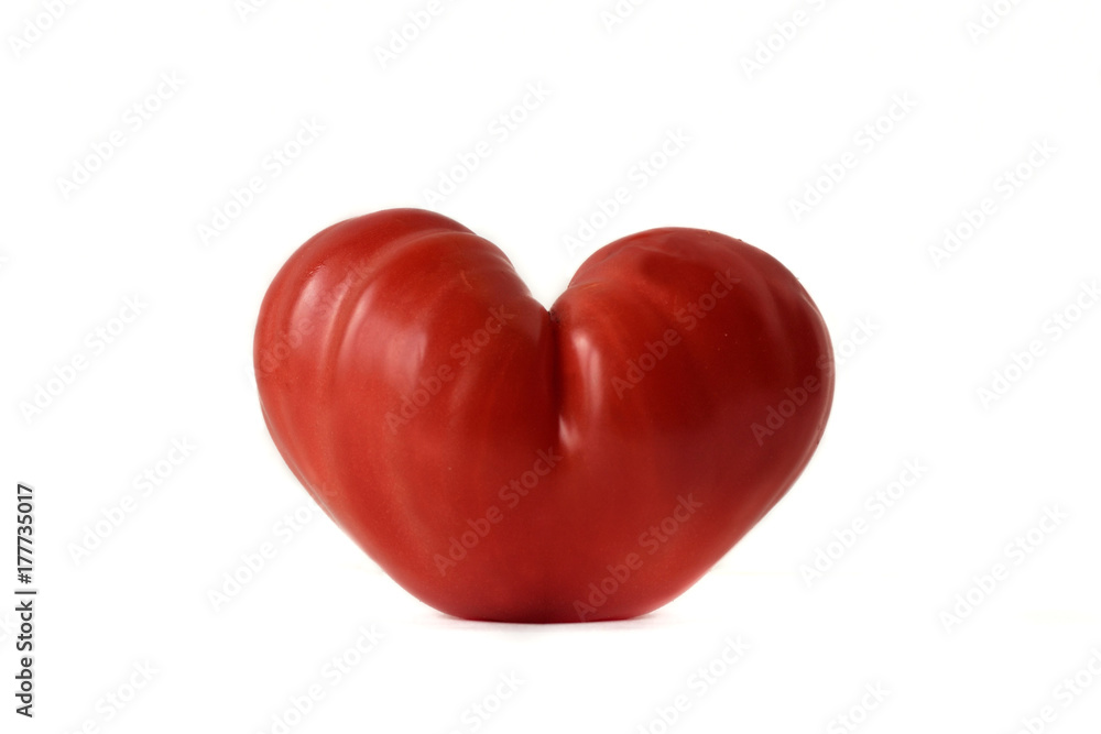 Heart shaped tomato on white background- Love concept