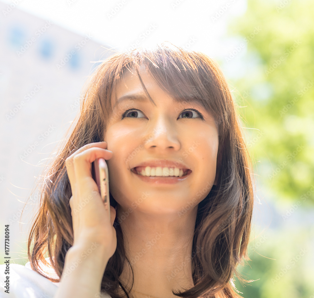 Beautiful asian young girl smiling speaking at the phone Beautiful asian young girl smiling speaking at the phone