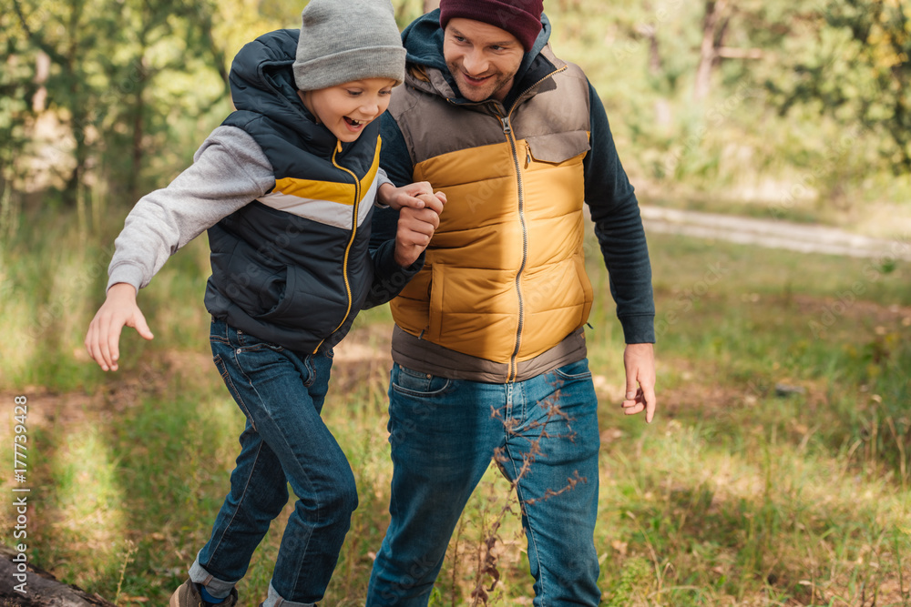 Fototapeta premium father and son walking in forest