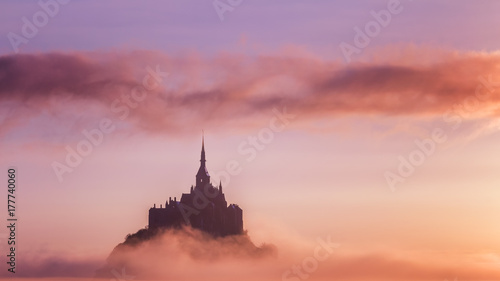 Beautiful panoramic view of famous Le Mont Saint-Michel tidal island at sunrise. Normandy, northern France