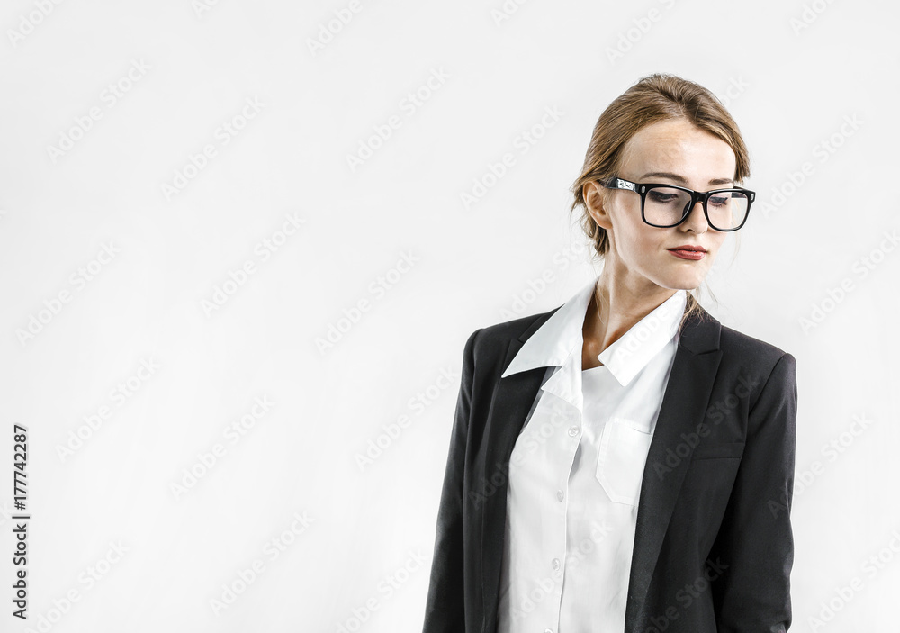 Young dark hair caucasian businesswoman wears glasses, in a white blouse and a black jacket in the white isolated background