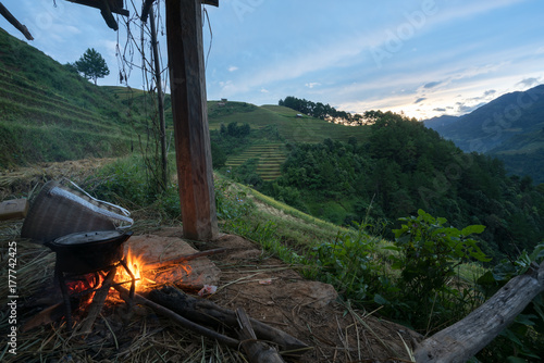 Cooking fire under house on stilts at dawn in terrace rice field in Mu Cang Chai  Vietnam
