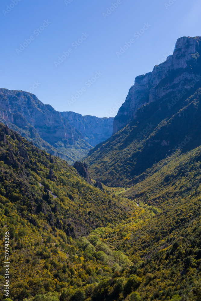 Vikos gorge in greece in autumn, mountains, blue sky
