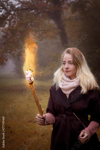 Young woman with a torch in hands.