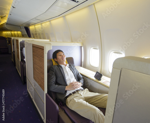 Принти на полотні Relaxed mid adult business man sleeping in first class seat