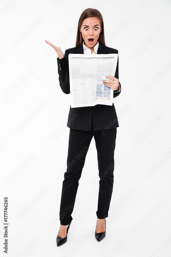 Shocked business woman holding newspaper. Shocked business woman holding newspaper.