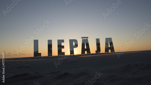 Beatiful sign Leipaja on Leipaja beach at sunset photo