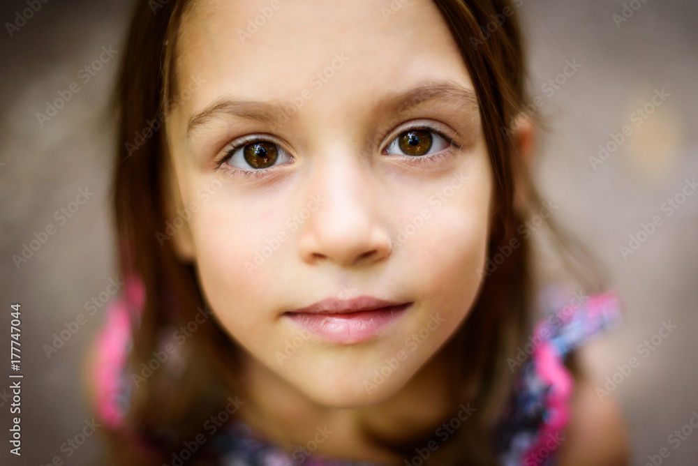 Portrait of little girl looking up at the parent outdoors. Portrait of little girl looking up at the parent outdoors.