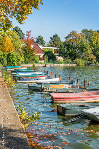 Row of old vintage colorful boats on the lake of Enghien les Bains near Paris, France