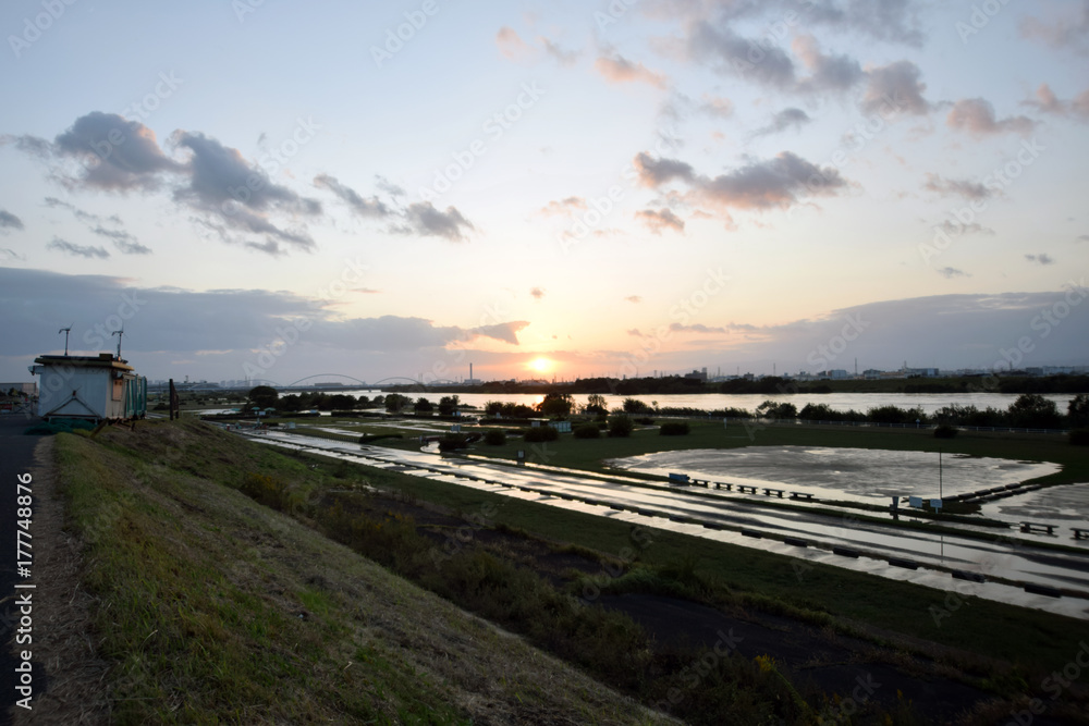A river and the setting sun after the typhoon.