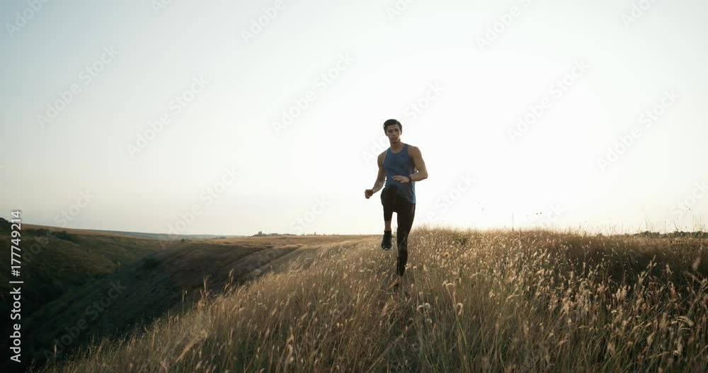 Young athletic man doing warm-up before exercise and jogging. Exercise in motion. Young athletic man doing warm-up before exercise and jogging. Exercise in motion.