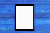 Tablet computer PC with blank screen mock up isolated on blue wood table background. Tablet on wood table. tablet white screen