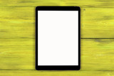 Tablet computer PC with blank screen mock up isolated on yellow wood table background. Tablet on wood table. tablet white screen