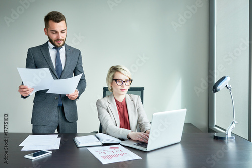 Obraz na plátně Group of hard-working financial managers gathered together at open plan office a