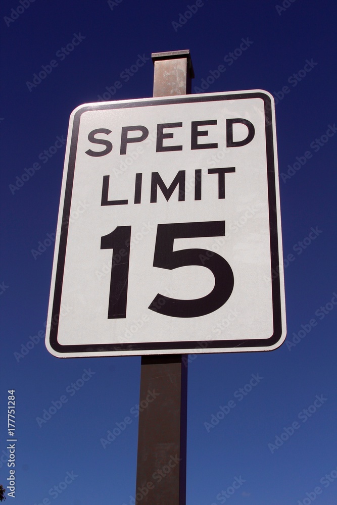The speed limit sign on a close up view and the blue sky in the background. The speed limit sign on a close up view and the blue sky in the background.
