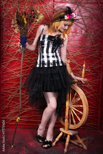  a witch on a broomstick, a stylish witch with red hair. Sorcery, enchantment, helovin photo