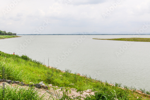 water way before dam with small green water bank and sky line