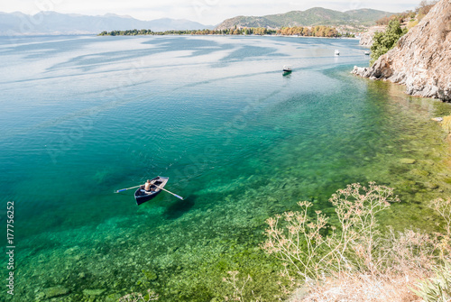 Man paddling in boat in calm Lake Ohrid, Macedonia