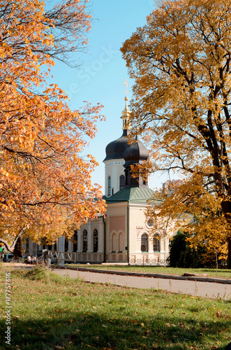 Holy Trinity Church stands in ancient botanical garden in Kiev, Ukraine. One of the most popular tourists places in Kiyv. Autumn garden landscape background