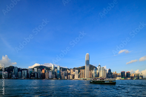 Hong Kong skyline cityscape, modern skyscraper building and ferry transportation traffic at sunrise morning © Pawin
