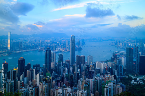 Cityscape of Hong Kong skyline and Victoria Harbor, view from the Peak at twilight sunset