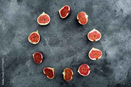Round frame of fig fruits or berries on dark background. Flat lay, Top view