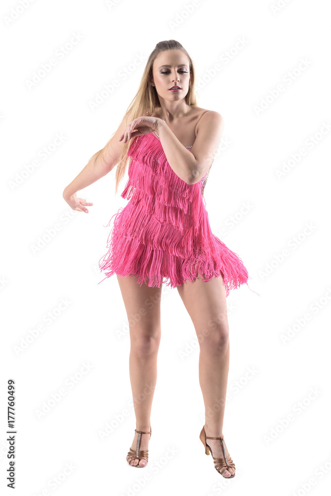 Gracious rumba female dancer swinging arms and hips looking down. Front view. Full body length portrait isolated on white studio background. 