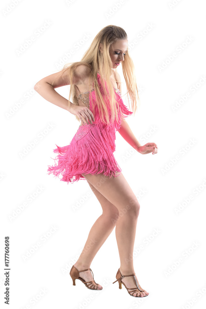 Emotional passionate latino dancer in pink dress looking down. Side view. Full body length portrait isolated on white studio background. Emotional passionate latino dancer in pink dress looking down. Side view. Full body length portrait isolated on white studio background.