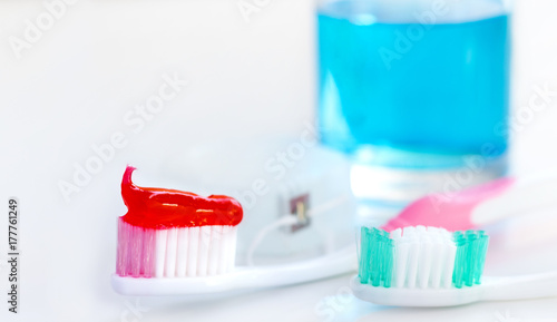 Toothbrush, mouthwash and toothpaste on white background