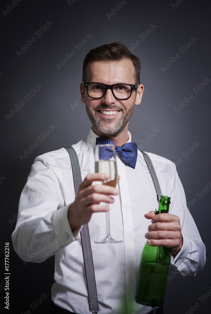 Elegant man with bottle of champagne and champagne flute Elegant man with bottle of champagne and champagne flute