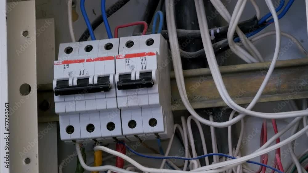 Switching Electric Breaker Box. Man hand turns on and off Electricity