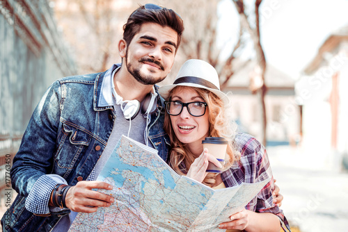 Love couple with a map on the street.