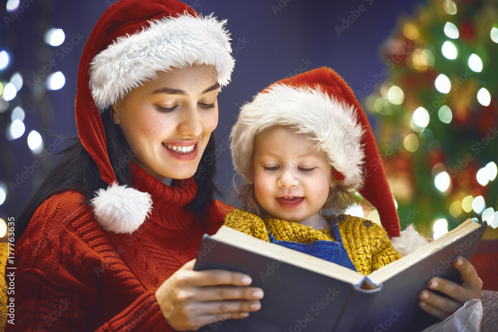 mother reading a book at Christmas mother reading a book at Christmas