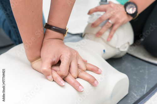 Nursing students are learning how to rescue the patient in emergency. CPR training with CPR doll. Closed-up. Soft focus.