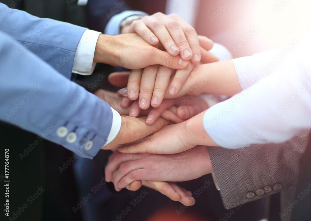 Creative team putting their hands together in circle Creative team putting their hands together in circle