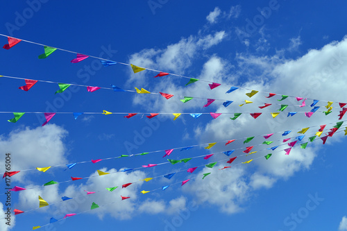 Colorful flags in foreground, background blue sky