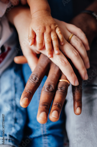 Close up of mixed race family holding hands