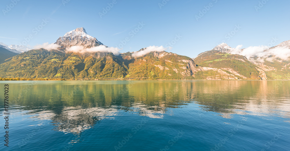 Autumn in the Alpine lake. Autumn gorgeous landscape in the Swiss Alps. Mountains reflected in Lake Lucerne.
