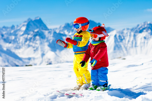 Ski and snow winter fun for kids. Children skiing.
