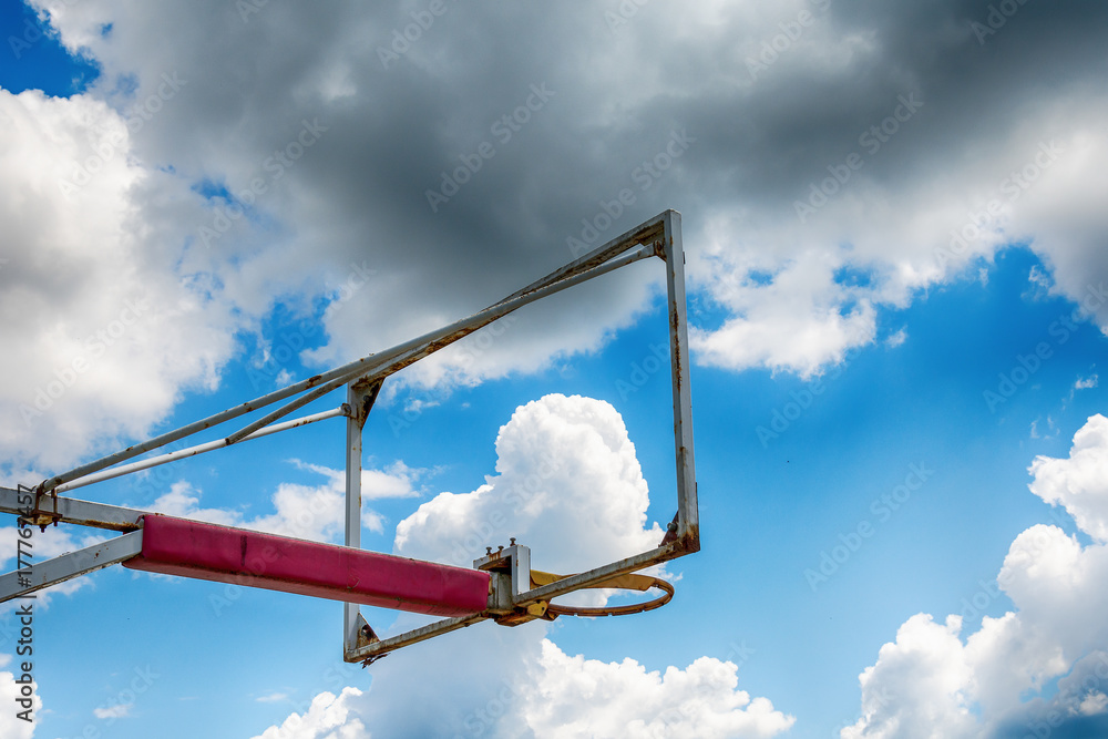 Old basketball hoop against blue sky Old basketball hoop against blue sky