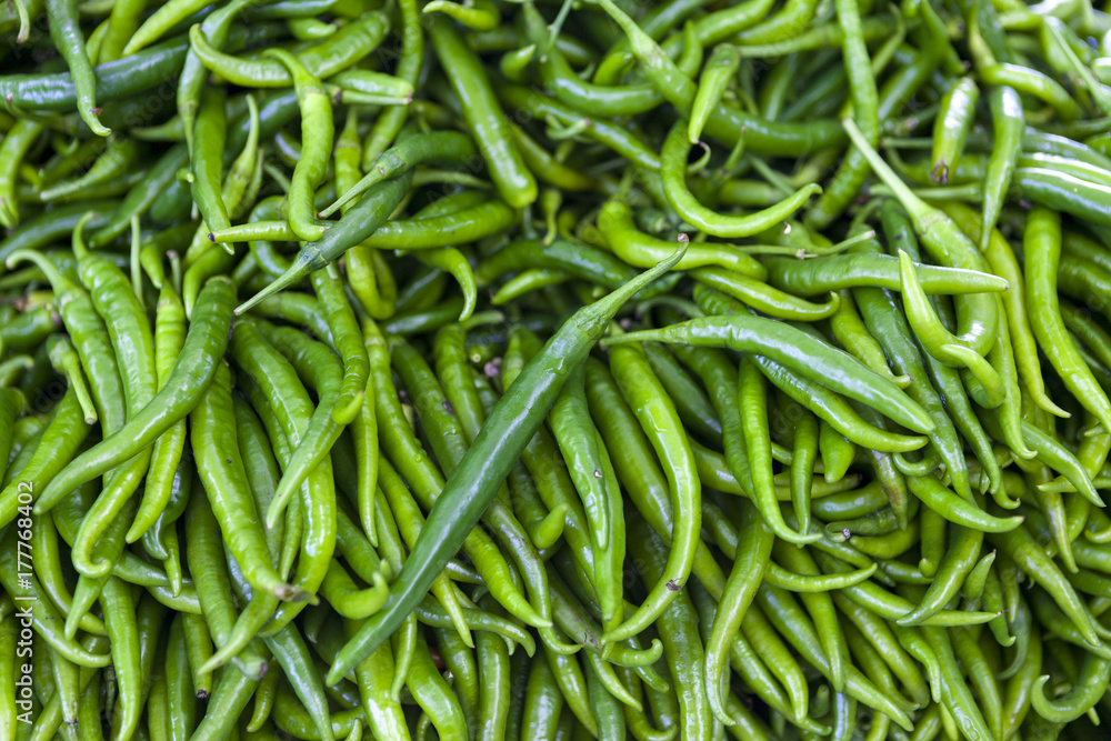 Green chilli peppers closeup on rustic market . Greece. Green chilli peppers closeup on rustic market . Greece.