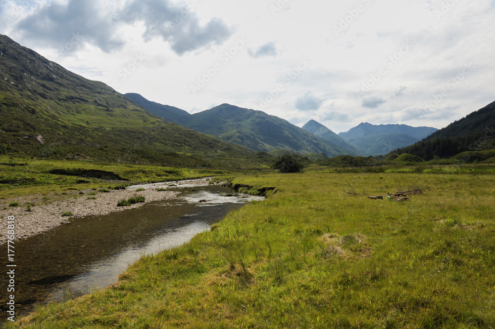 Small river in the Scotland Highlands with mountains Small river in the Scotland Highlands with mountains