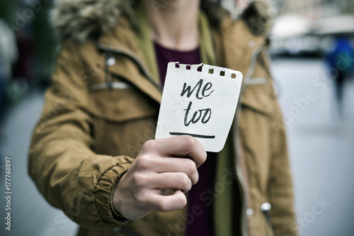 woman showing a note with the text me too photo