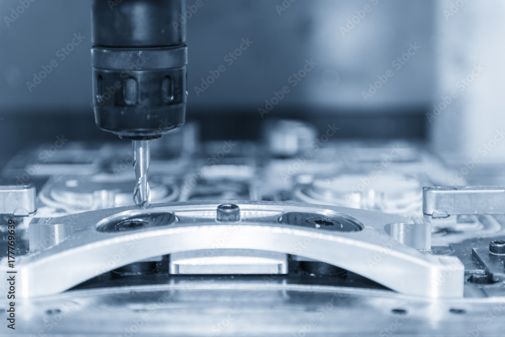 The CNC milling machine cutting cutting the raw material with the small ball-end mill tool .Hi-precision CNC machining concept. The CNC milling machine cutting cutting the raw material with the small ball-end mill tool .Hi-precision CNC machining concept.