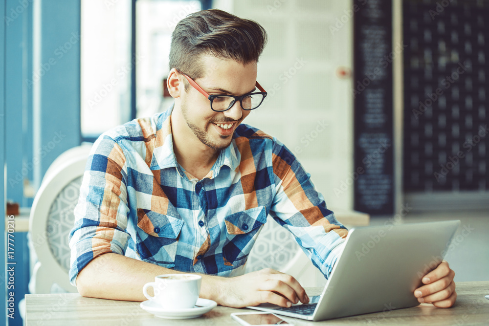 Man enjoying coffee and working Man enjoying coffee and working