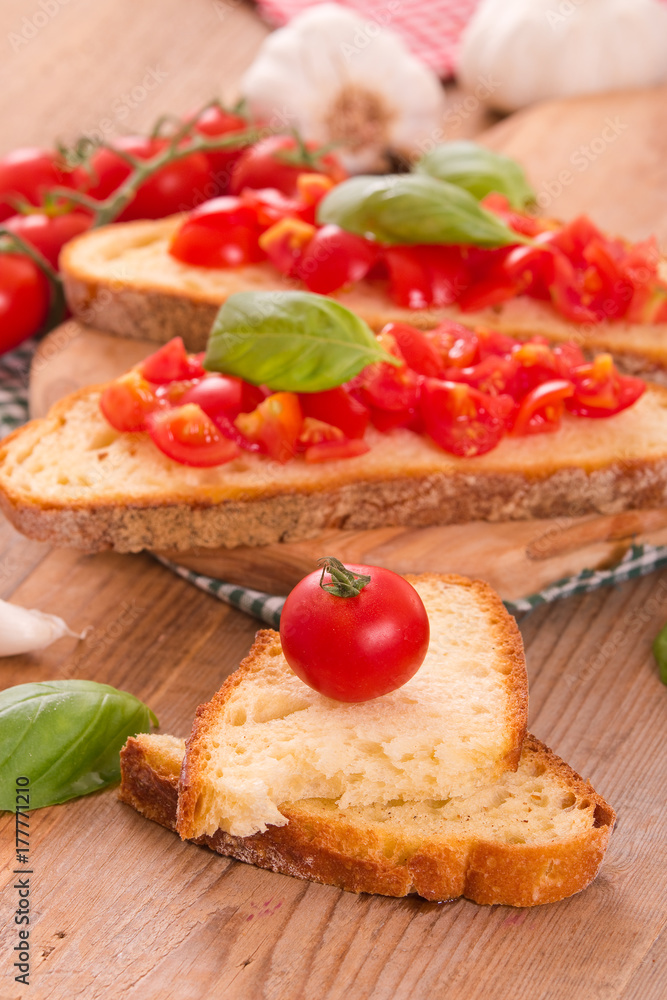 Bruschetta bread with basil and chopped tomatoes. 