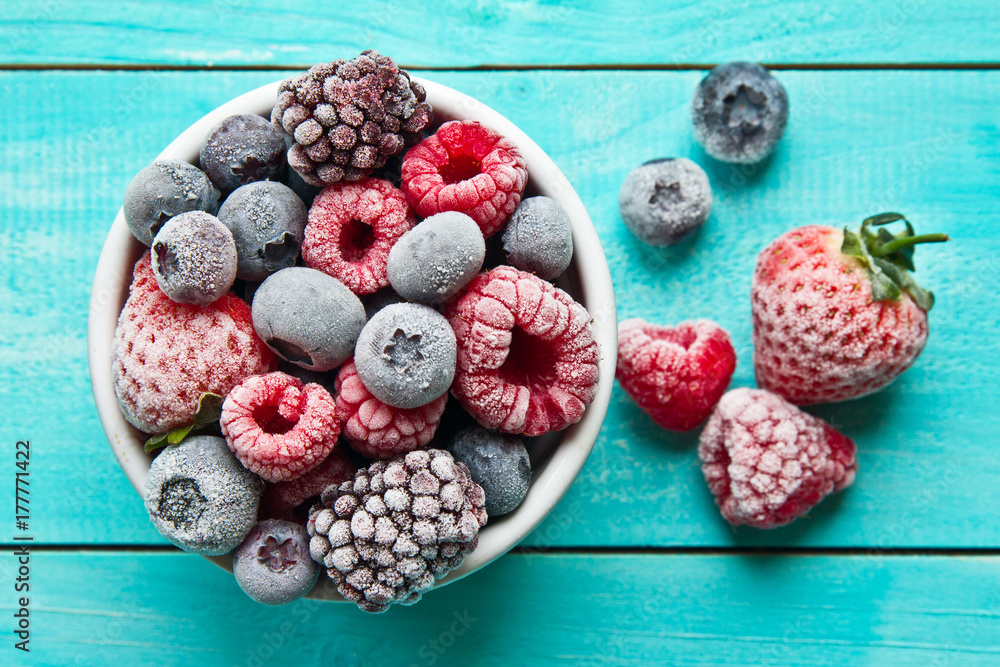 Frozen berries in a bowl closeup. Frozen berries. - obrazy, fototapety, plakaty 