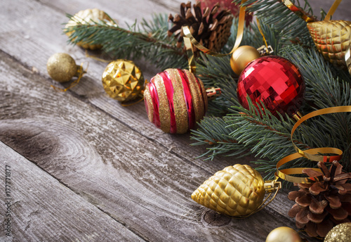 Christmas red and golden toys on old wooden background